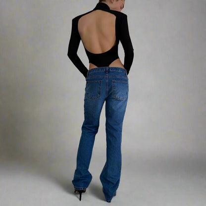 Model wearing the Bold Allure Open-Back Long Sleeve Bodysuit in black, ideal for stylish travel outfits