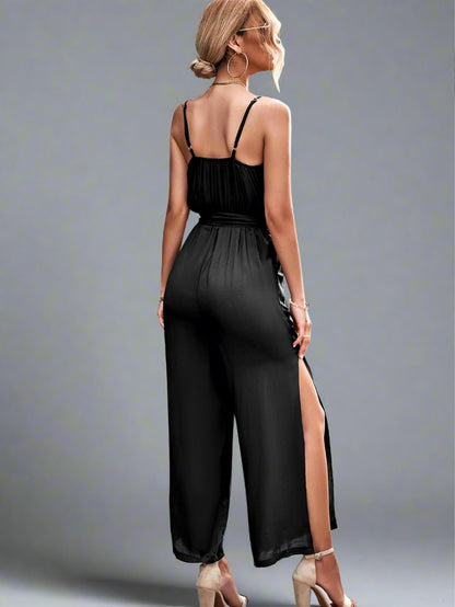 Woman wearing the Oasis Wide-Leg Jumpsuit in black perfect for vacation.