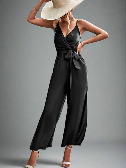Woman wearing the Oasis Wide-Leg Jumpsuit in black, perfect for vacation.