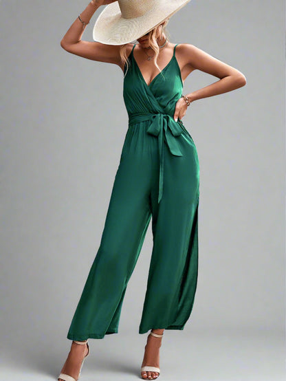 Woman wearing the Oasis Wide-Leg Jumpsuit in green, perfect for vacation.