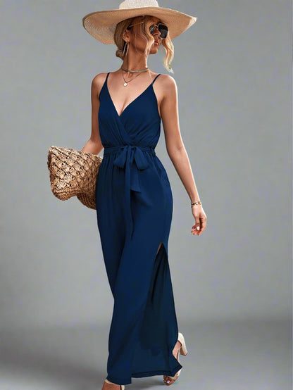 Woman wearing the Oasis Wide-Leg Jumpsuit in blue, perfect for vacation.