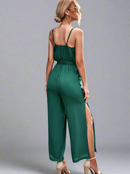 Woman wearing the Oasis Wide-Leg Jumpsuit in green, perfect for vacation.
