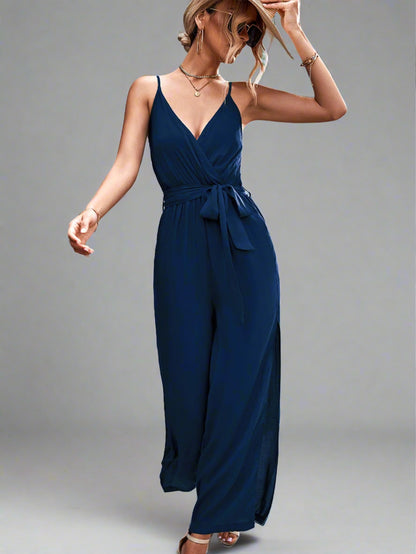 Woman wearing the Oasis Wide-Leg Jumpsuit in blue, perfect for vacation.