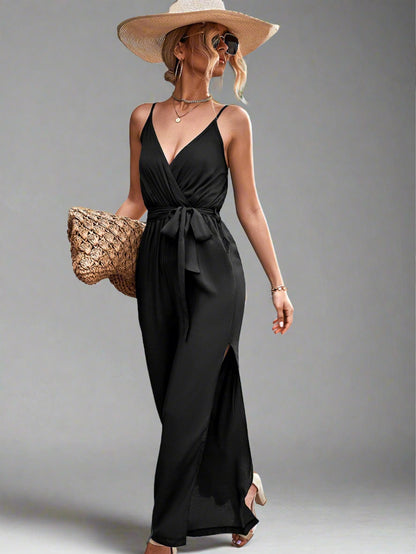 Woman wearing the Oasis Wide-Leg Jumpsuit in black, perfect for vacation.